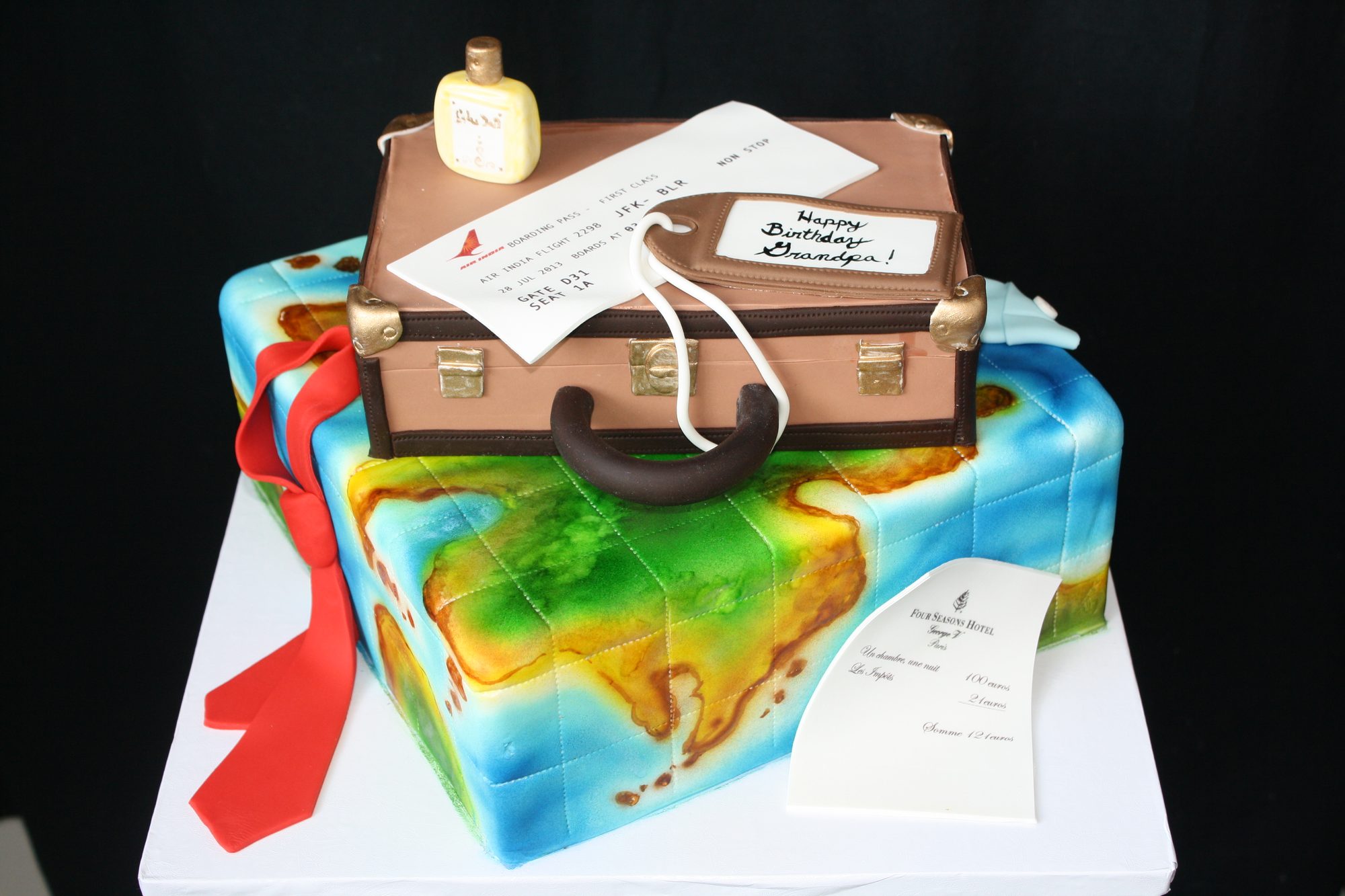 World map and suitcase birthday cake